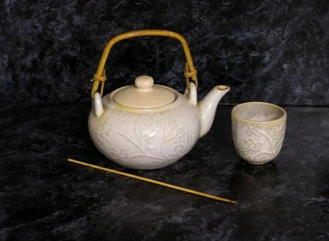 Stack of antique ceramic cups, teapot on a white background.vintage Stock Photos