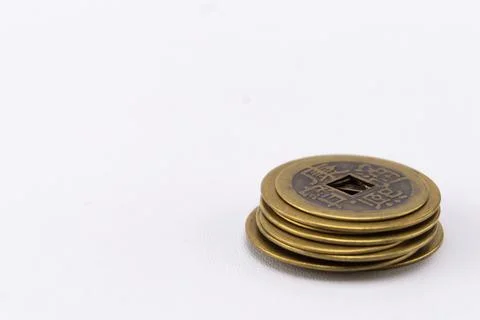 Stack of Antique Chinese Coins with Square Holes on White Background, Close-U Stock Photos