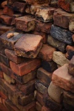 Stack of antique earthen red-black bricks background Stock Photos