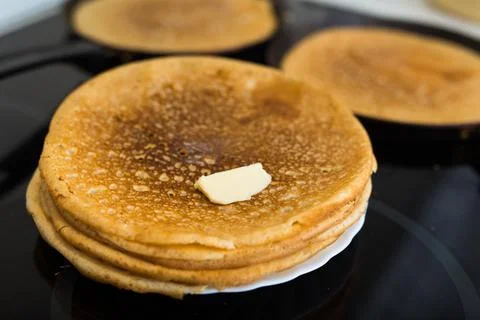 Stack of appetizing flour pancakes in the kitchen during cooking Stock Photos