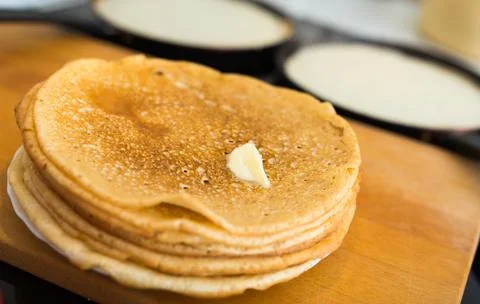 Stack of appetizing flour pancakes in the kitchen during cooking Stock Photos