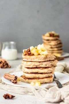 Stack of apple pancakes with caramelized apples and spices (anise and cinnamon). Stock Photos