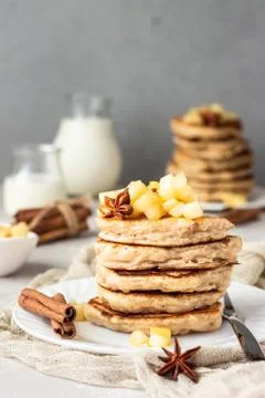 Stack of apple pancakes with caramelized apples and spices (anise and cinnamon). Stock Photos