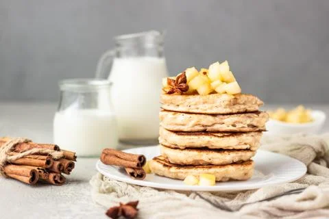 Stack of apple pancakes with caramelized apples and spices (anise and cinnamon). Stock Photos