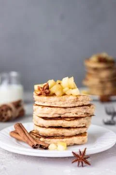 Stack of apple pancakes with caramelized apples and spices (anise and cinnamon). Stock Photos
