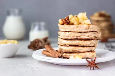 Stack of apple pancakes with caramelized apples and spices (anise and cinnamon). Stock Photos