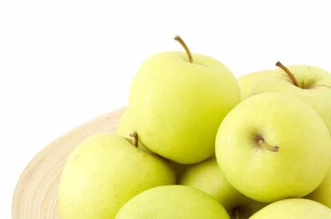 Stack of apples on wooden plate Stock Photos