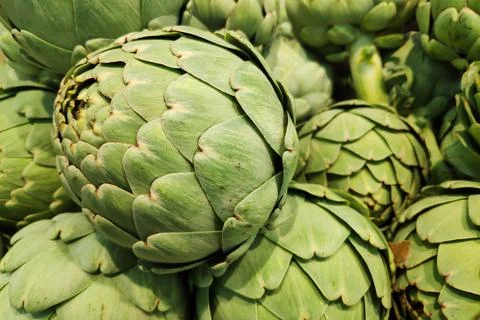 Stack of artichokes on a market stall Stock Photos