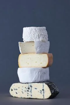 Stack Of Artisan Organic Cheese Against Grey Background Stock Photos