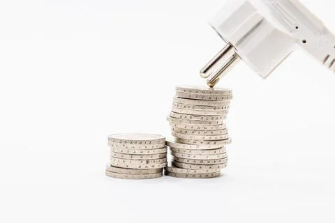 Stack of ascending coins and electric plug. Concept of the increasing Stock Photos