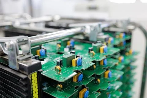 Stack of assembled printed circuit boards in rack at modern electronics facto 스톡 사진