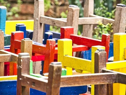 Stack of assorted colored wooden chairs in random disarray, full frame furn.. Stock Photos