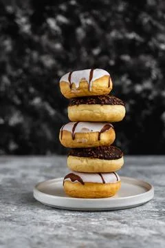 Stack of assorted donuts on a white plate. Chocolate donuts. Foto stock