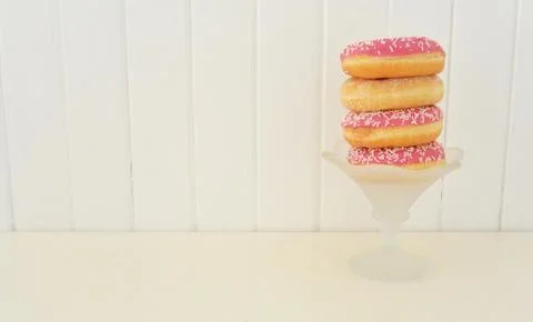Stack of assorted donuts. Wooden planks background Stock Photos