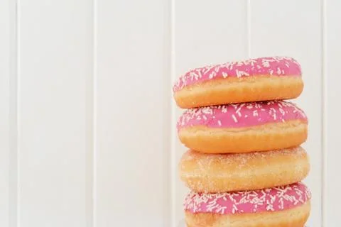 Stack of assorted donuts. Wooden planks background Stock Photos