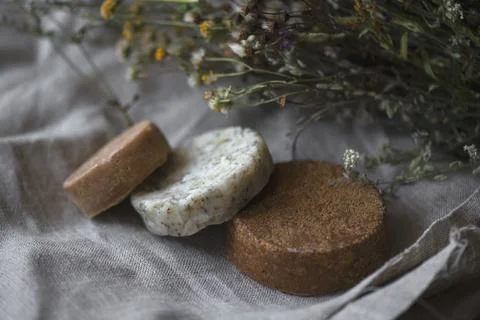 Stack of assorted natural soap bars on linen textile cloth. Pastel colors. eco Stock Photos