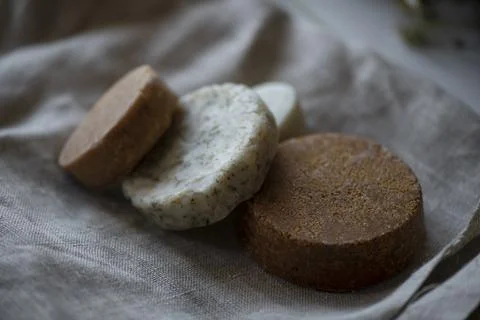 Stack of assorted natural soap bars on linen textile cloth. Pastel colors. eco Stock Photos