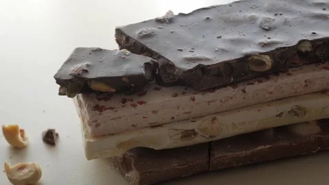 Stack of Assorted Nougat Bars with Rich Chocolate and Nuts Stock Footage 321790250
