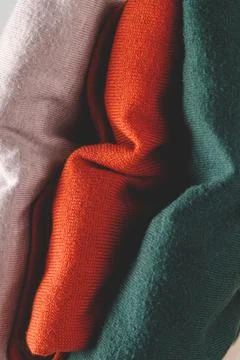 Stack of autumn basic women's turtlenecks in trendy colors. Minimalist basic Stock Photos