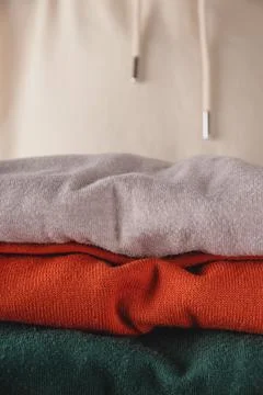 Stack of autumn basic women's turtlenecks in trendy colors. Minimalist basic Stock Photos