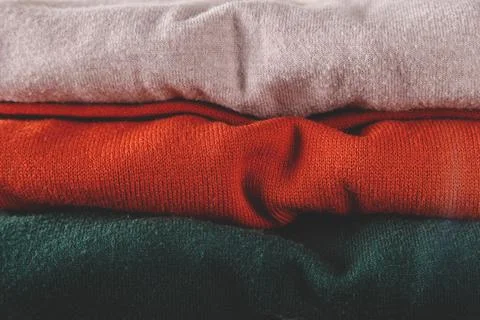 Stack of autumn basic women's turtlenecks in trendy colors. Minimalist basic Stock Photos