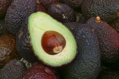 Stack of avocados on a market stall Stock Photos