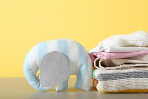 A stack of baby clothes on a light background. 스톡 사진