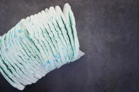 Stack of baby diaper on black background , Stock Photos