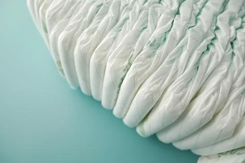 Stack of baby diaper on light green background Stock Photos