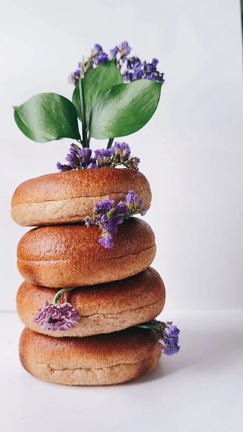 Stack of bagels with flowers intertwinged together Stock Footage 270323787