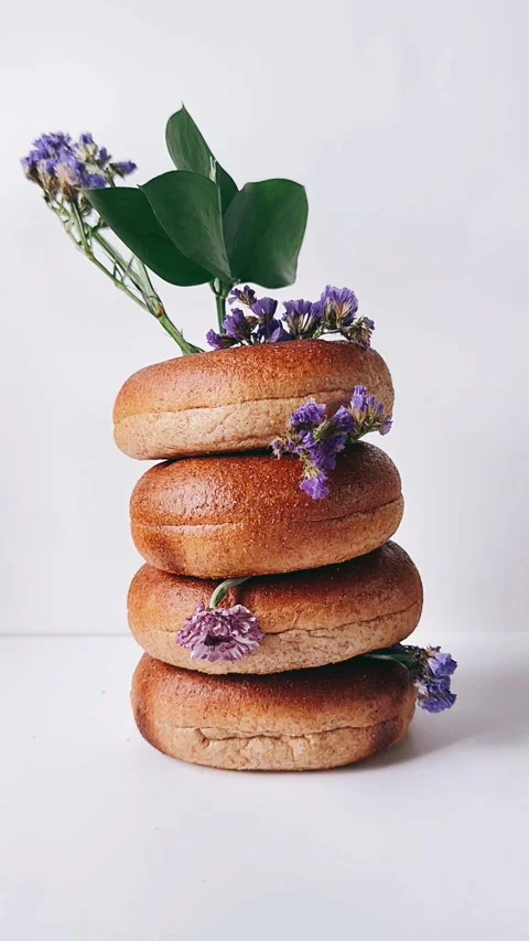 Stack of bagels with flowers intertwinged together Stock Footage 270323898