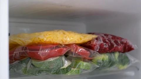 Stack of bags of chopped vegetables and berries in the refrigerator. Stock Footage 342086559