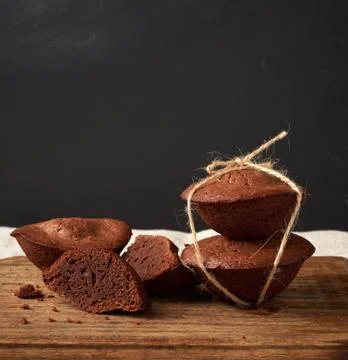 Stack of baked brownie round cakes tied with a rope on a brown wooden board Stock Photos