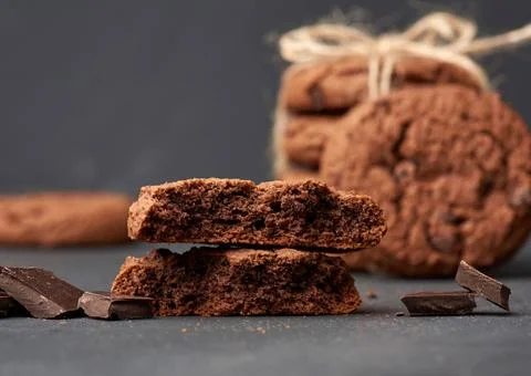 Stack of baked round chocolate chip cookies and pieces of chocolate stack ... Stock Photos