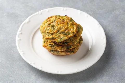 Stack of baked vegetable fritters with spinach and zucchini served - Turkis.. Stock Photos