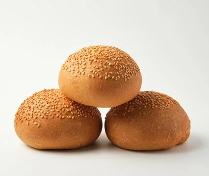 Stack of baked whole round bun with sesame seeds Fotos Stock