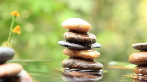 Stack of Balanced rocks pyramid on water with Golden light natural peace con Stock-Footage 260201133