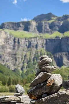 Stack of balancing rocks symbolising peace and mindfulness over a lush moun.. Stock Photos