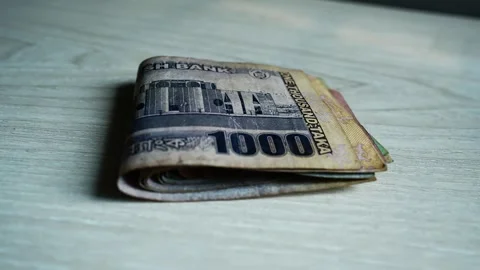 Stack of Bangladeshi Taka Banknotes, A stack of folded Bangladeshi Taka ban.. Stock Footage 304911343