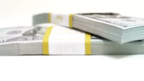 Stack of bank bundles with US dollars on a white background. Close-up shot of Stock Footage 241404055