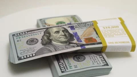 Stack of bank bundles with US dollars on a white background. Close-up shot of Stock Footage 241566015