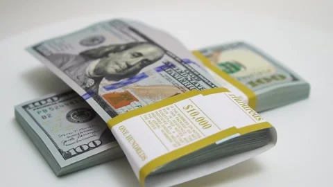 Stack of bank bundles with US dollars on a white background. Close-up shot of Stock Footage 241714657