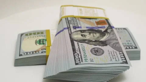 Stack of bank bundles with US dollars on a white background. Close-up shot of Stock Footage 241782512