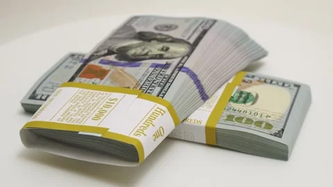 Stack of bank bundles with US dollars on a white background. Close-up shot of Stock Footage 241898540