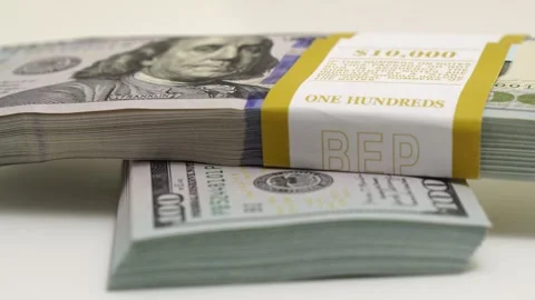 Stack of bank bundles with US dollars on a white background. Close-up shot of Stock Footage 242319090