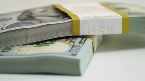 Stack of bank bundles with US dollars on a white background. Close-up shot of Stock Footage 242399863