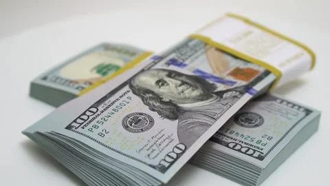 Stack of bank bundles with US dollars on a white background. Close-up shot of Stock Footage 242578122