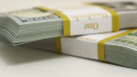 Stack of bank bundles with US dollars on a white background. Close-up shot of Stock Footage 242658041