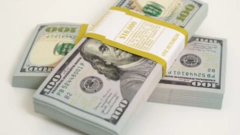 Stack of bank bundles with US dollars on a white background. Close-up shot of Stock Footage 242755498