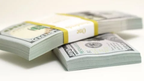 Stack of bank bundles with US dollars on a white background. Close-up shot of Stock Footage 242835189